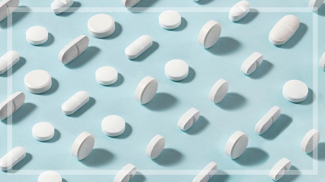 several white pills on blue background